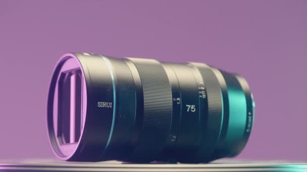 FRANCE, PARIS - MARCH 21, 2022: Large wide angle lens. ACTION. Showing a new lens on a purple background. Large zoom lens for SLR camera — Stock Video