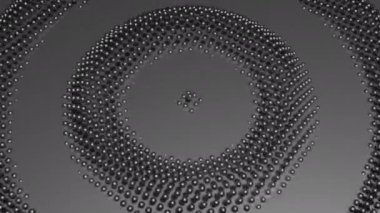 Monokrom küçük metal toplardan oluşan halkalar yayıyor, dikişsiz döngü. Tasarım. Küçük kürelerden oluşan gri daireler