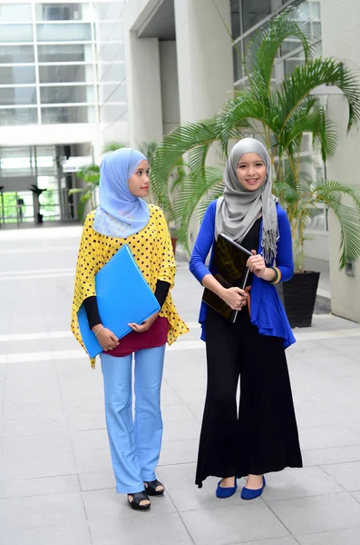 Two young pretty Asian muslim business woman in head scarf — Stock Photo, Image