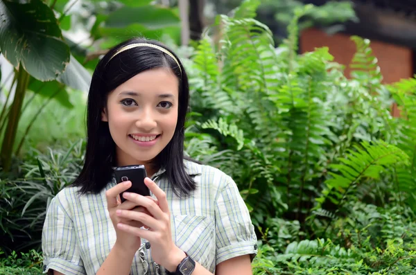 Beautiful portrait young teenager girl outdoor with mobile phone — Stock Photo, Image