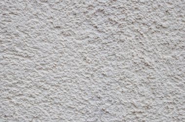 Alçılı ışık duvarı. Düzensiz yamalarla birlikte asimetrik desen biçiminde arkaplan