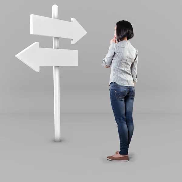 Girl before a roadsign — Stock Photo, Image