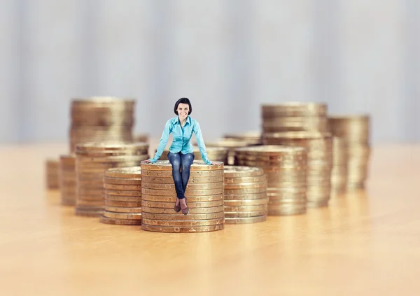 Girl on coins — Stock Photo, Image