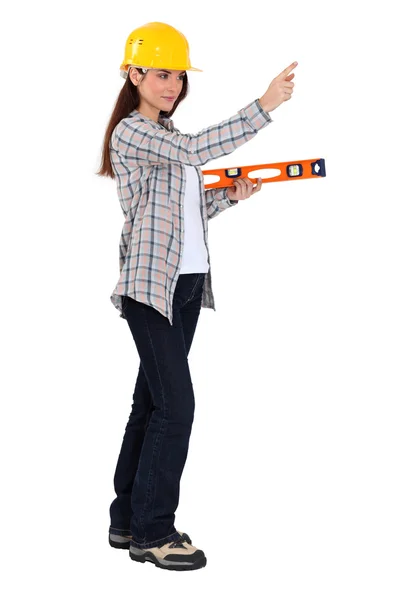 Woman holding spirit-level Stock Picture