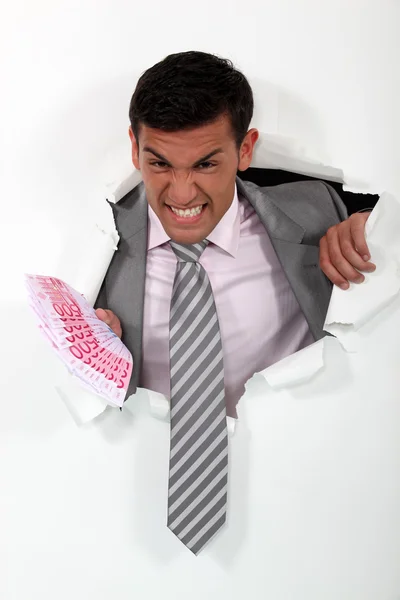 Desperate businessman with a handful of cash — Stock Photo, Image