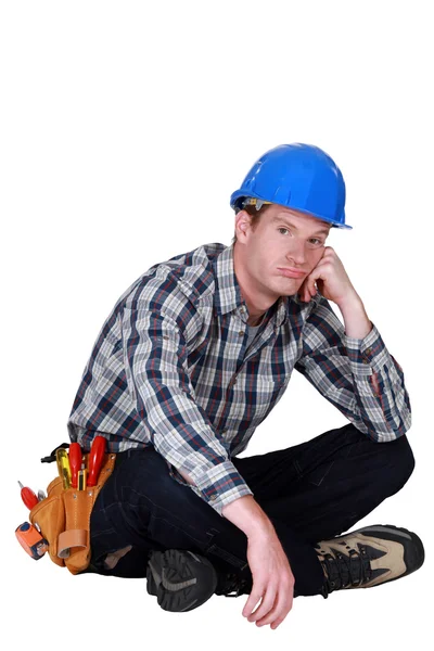 Bored builder sat on the floor — Stock Photo, Image