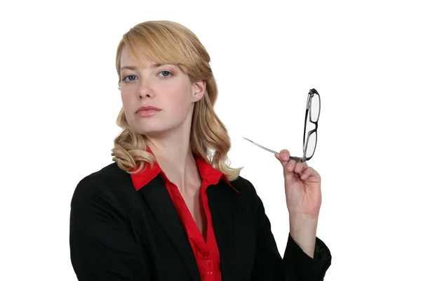 Blonde businesswoman holding her head high up with glasses — Stock Photo, Image