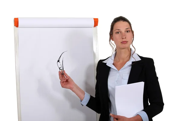 Businesswoman stood in front of flip chart Stock Photo