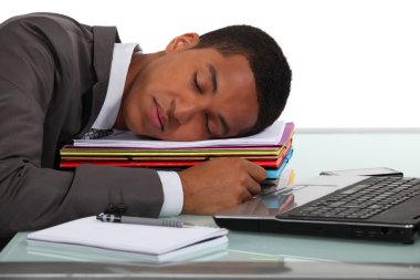 Businessman asleep at his desk clipart