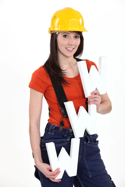 Woman construction worker holding WWW letters — Stock Photo, Image