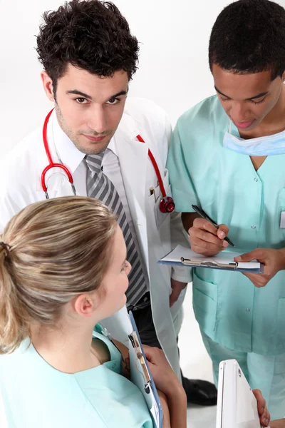 A team of medical professionals conferring — Stock Photo, Image