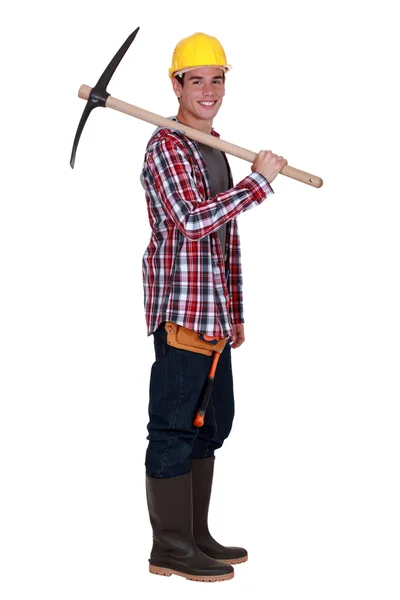 Young quarry worker with pick axe — Stock Photo, Image