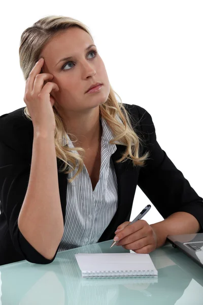 Blonde secretary lost in thoughts Stock Picture