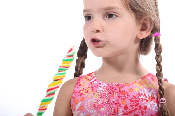 Young girl eating candy — Stock Photo, Image