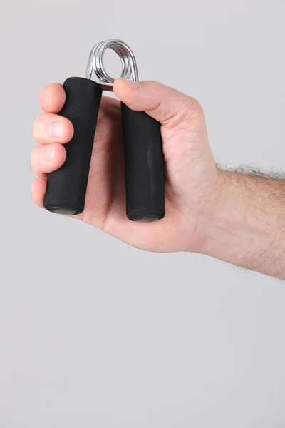 Mannen med en hand exerciser — Stockfoto