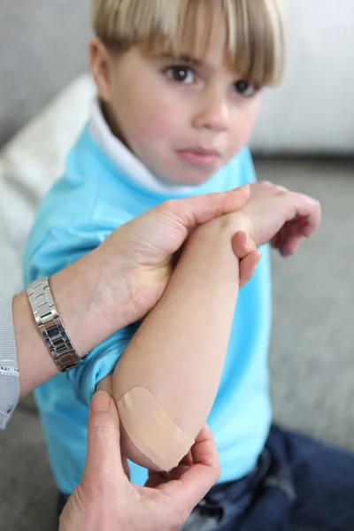 Little boy with a bandage on arm — Stock Photo, Image