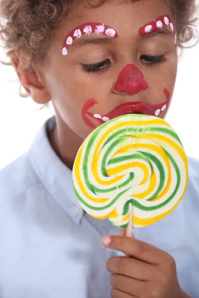 Little boy made-up sucking lollipop — Stock Photo, Image