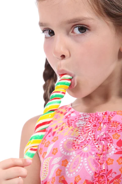 Little girl licking a lollipop — Stock Photo, Image