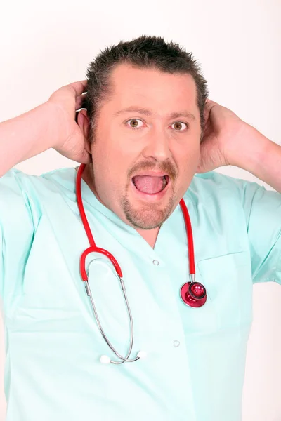 Doctor in scrubs shouting to be heard — Stock Photo, Image