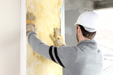 Craftsman insulating a wall clipart