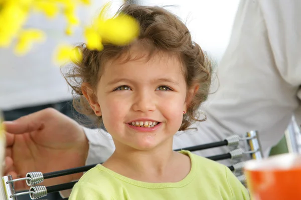 Little girl eating breakfast outdoors — Stock Photo, Image