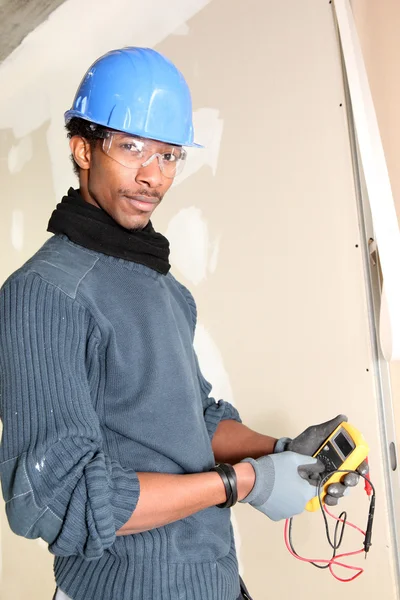 Young electrician with multimeter — Stock Photo, Image