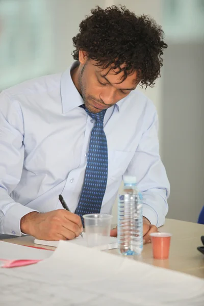 Retrato de un hombre de negocios escribiendo en un bloc de notas —  Fotos de Stock