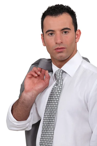 Confident businessman with jacket over shoulder — Stock Photo, Image