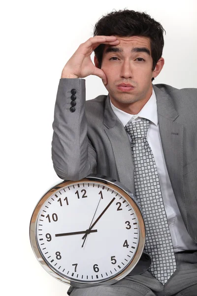 Business with clock suffering from headache — Stock Photo, Image