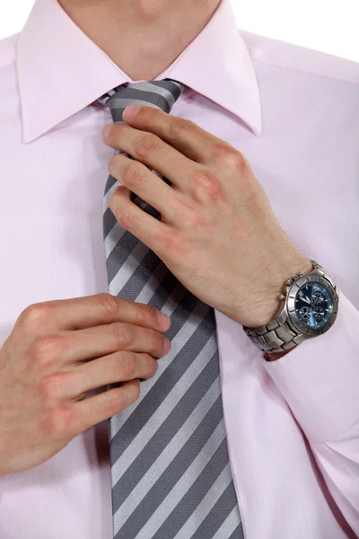 Businessman fixing his tie — Stock Photo, Image