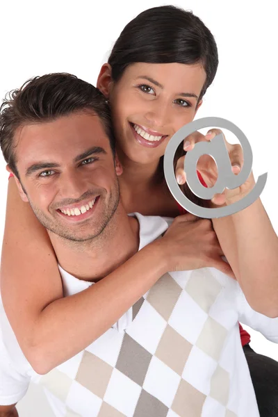 Couple holding at symbol — Stock Photo, Image