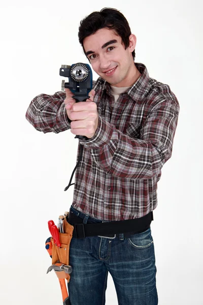 Craftsman using a drill as a gun — Stock Photo, Image