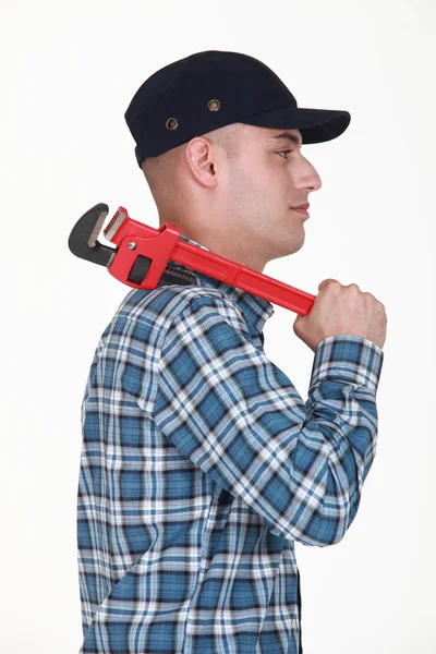 Builder carrying wrench over shoulder — Stock Photo, Image