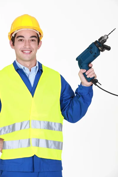 Trabajador de la construcción con un taladro — Foto de Stock