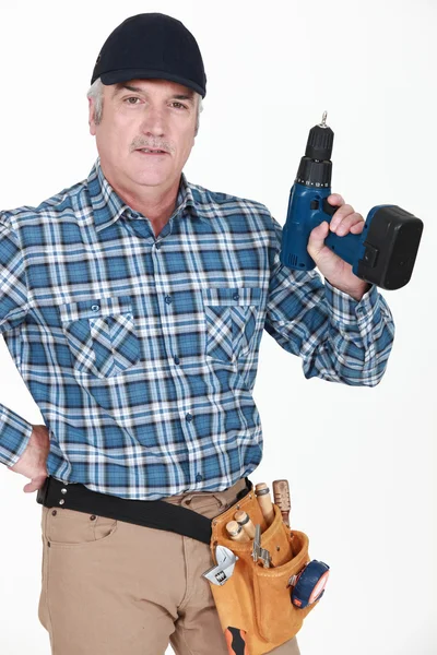 Picture of mature carpenter holding drill — Stock Photo, Image