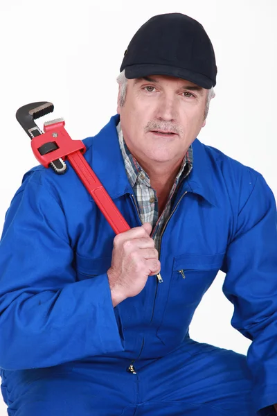 A mature man with a wrench. — Stock Photo, Image