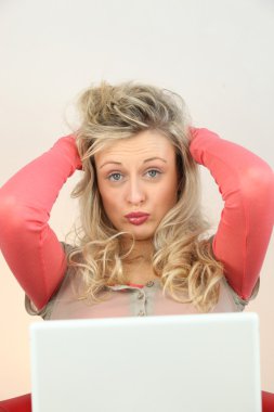 Woman being driven crazy by her computer clipart
