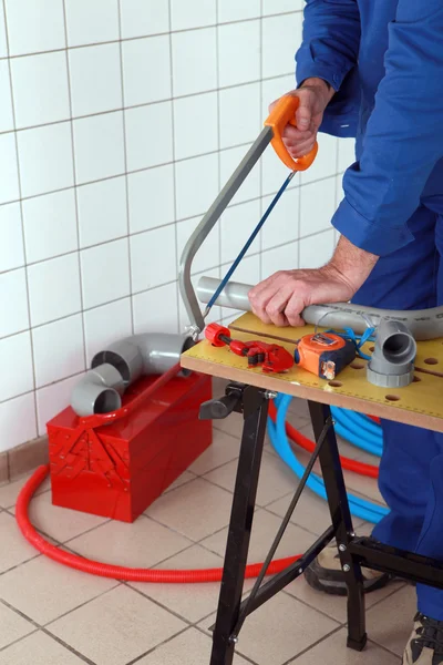 Plumber sawing tube — Stock Photo, Image