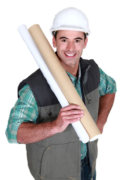 Tradesman holding building drawings — Stock Photo, Image