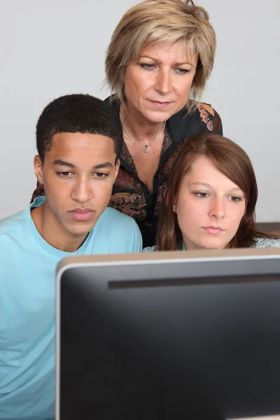 Female teacher with two pupils — Stock Photo, Image