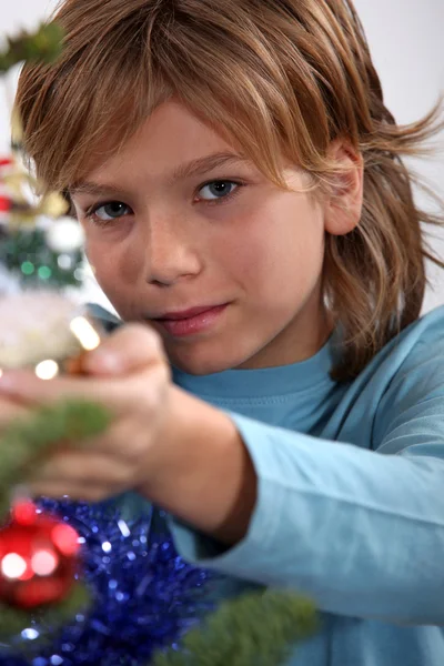 Boy decorating a Christmas tree — Stock Photo, Image
