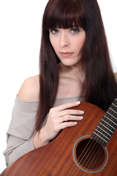Portrait of woman holding guitar Royalty Free Stock Photos