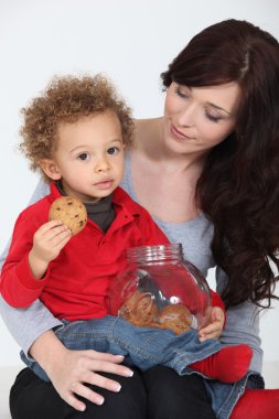Cute child eating cookies clipart