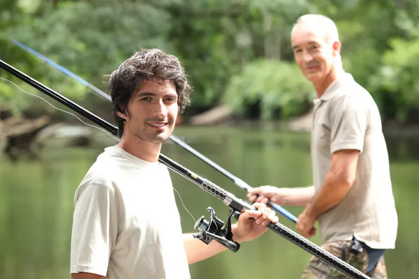 Men fishing at a lake Stock Photo