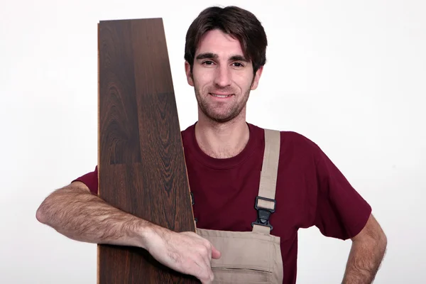 Uomo con pavimento in legno — Foto Stock