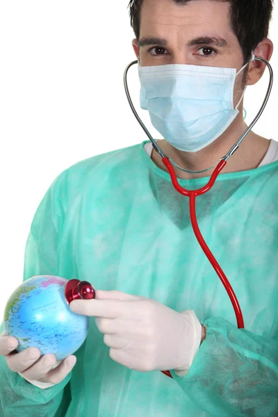 Doctor listening the beat of the globe — Stock Photo, Image