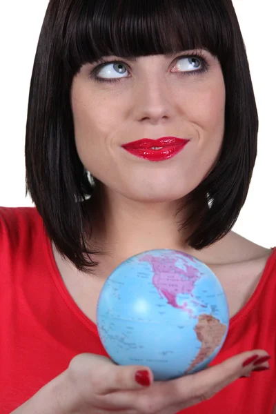 Woman in red holding planet earth — Stock Photo, Image