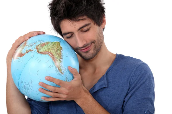 Un homme étreignant un globe — Photo