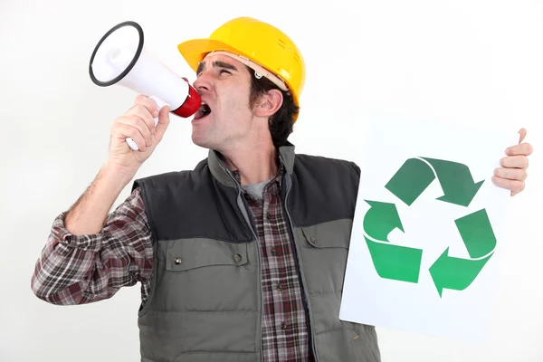 Craftsman holding a recycling label and shouting through a megaphone — Stock Photo, Image