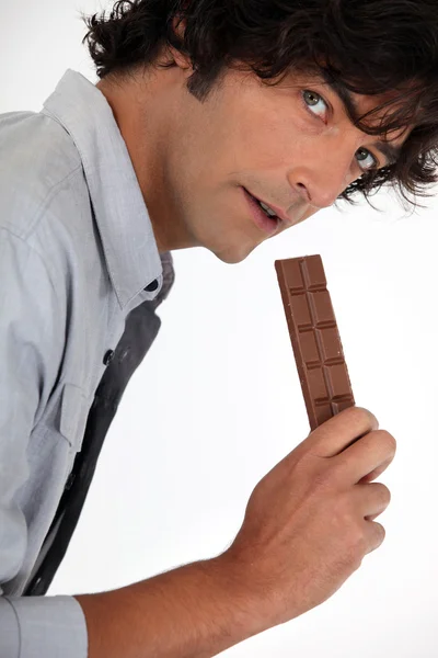 Young man with chocolate bar — Stock Photo, Image